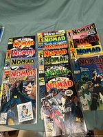 Photo of Nomad comic books issues 1-12 and 1-4 laid out to show full titles and cover art.