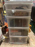 Full view of five-drawer plastic storage organizer filled with various items