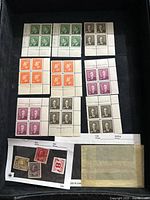 Photo of multiple blocks of four unused Canadian stamps in various colors and denominations