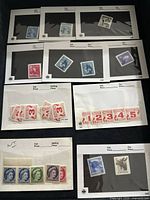 Several Canadian stamps displayed on black pages including numeric value strips and various Queen Elizabeth II designs.