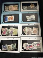 Album pages displaying various used Chinese stamps including flags, buildings, and other designs.