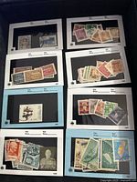 Multiple Chinese stamps mounted on album pages showing various themes and figures.