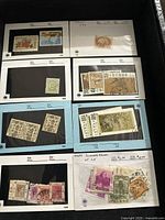 Blue and white album pages showing multiple used Chinese stamps with various designs and denominations.