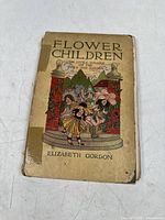 Front cover of the book 'Flower Children' by Elizabeth Gordon featuring an illustration of children dressed as flowers and title text. Shows wear and tape repair.
