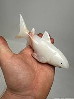 Front and top angled view of the polished white onyx shark figurine showing smooth finish and natural veining