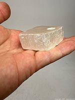 Selenite specimen in hand showing translucent crystal and rough edges