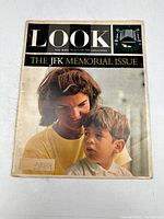 Front cover showing woman and boy, titled 'The JFK Memorial Issue'.