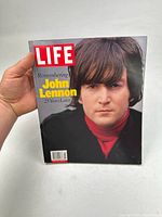 Front cover of LIFE magazine featuring a portrait of John Lennon with a red turtleneck and black jacket.