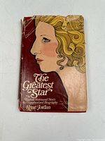 Front view of the book cover showing title, author, and illustrated portrait of a woman against a red background. Shows wear and tear on dust jacket edges.