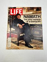 Front cover of the Life magazine showing Joe Namath in a seated pose indoors with headline about him.