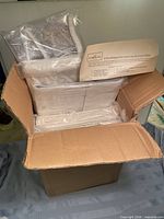 Box containing sealed white hanging organizers and instruction sheet visible