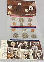 Outer envelope with both red and blue cellophane coin packs visible