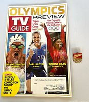 Front cover of August 8-21 2016 TV Guide Olympics preview magazine beside Coca-Cola Olympic lapel pin
