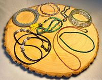 Group shot showing all jewelry pieces arranged on wooden slab