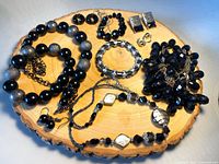 Overview of all jewelry pieces on wood slice