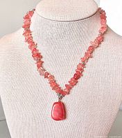 Necklace on display bust showing chips and pendant