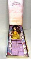 Belle doll inside open original box showing gown and accessory