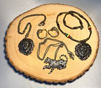 Overview of all jewelry pieces on wooden slice
