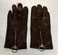 Front view of both gloves showing zippers and ring pulls