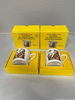 Two cups in their open yellow boxes showing artwork and box text