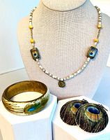 Full view of necklace on bust, bracelet, earrings display