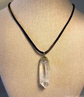 Necklace displayed on bust showing pendant and cord