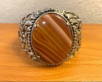 front view showing banded red carnelian agate cabochon and filigree design