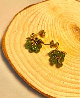 Front view of jade cluster earrings on wood slice