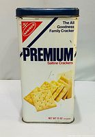 Front view of Nabisco Premium Saltine Crackers tin showing main branding and crackers image