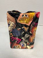 Front view of ceramic tote bag showing Barbie collage and handles