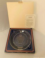 Plate in open presentation box with certificate visible