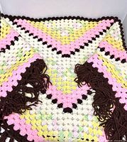 Full view of triangular shawl showing color pattern and fringe