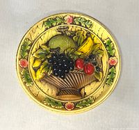 Front view of chalkware plaque showing fruit design and border