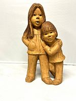 Front view showing full sculpture of girl and boy