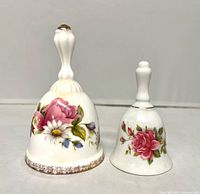 Front view of both ceramic bells showing rose decorations and size comparison