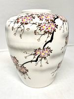 Front of white ceramic vase with floral branch design