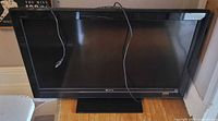 Front view of the 42-inch Sony Bravia television on stand, power cord visible.