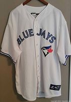 Front view of white Blue Jays away jersey with "BLUE JAYS" text and Blue Jays logo embroidered, size 2X.