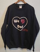 Front full view of the black pullover sweater showing the overall style and design.