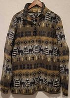 Full view of fleece sweater showing patterned design and half-zip front