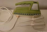 Green Samson-Dominion hand mixer with beaters and additional mixing attachment, cord visible