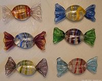 Full set of six vintage glass candy decorations showing various colors and striped patterns.