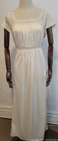 Full front view of the vintage cream nylon St. Michael nightgown on dress form showing length and design.