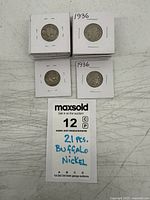 Stacked 2×2 holders showing two coins dated 1936