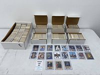 Overview of five full boxes, one partial box and seventeen sleeved cards laid out