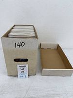 Full short box of bagged comics with lot number 140 visible