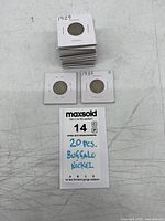 Stack of twenty coin flips showing two labeled 1929 and 1935-S