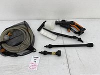 Whole lot with power washer, hose in mesh bag, brush, wands, soap bottle