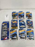 All ten sealed Hot Wheels packages arranged on table