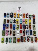Top-down view of all 50 Hot Wheels cars arranged in five rows